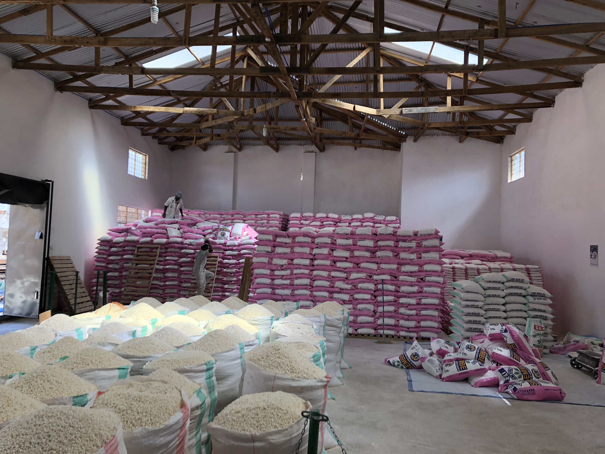 Storage warehouse with pink lina bags stacked up